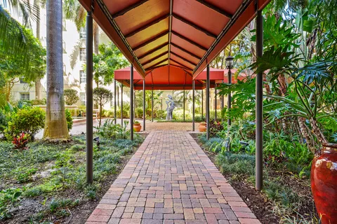 a view of a patio with a table and chairs and potted plants