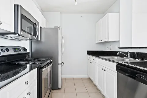 a kitchen with stainless steel appliances a stove a sink and a refrigerator