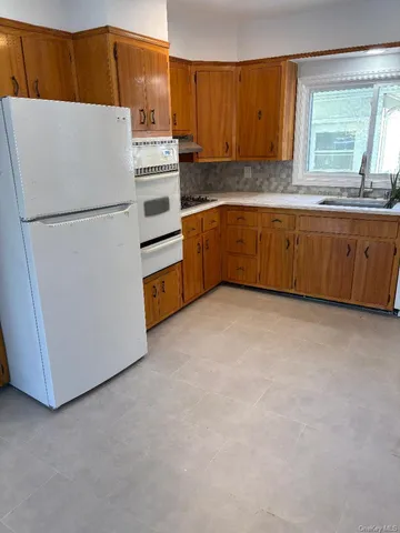 a kitchen with stainless steel appliances a refrigerator sink and cabinets