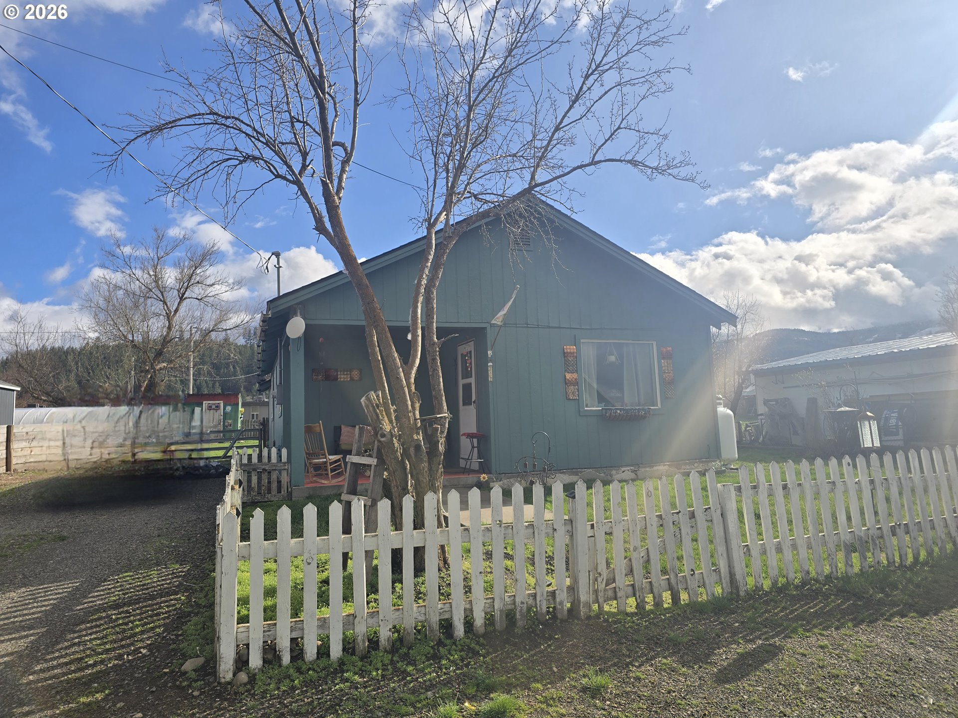 302 West 3rd Street Wallowa, OR 97885 - Photo 2 of 10 a front view of house with wooden fence