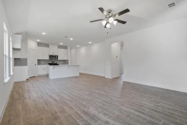 a view of kitchen with refrigerator microwave and stove
