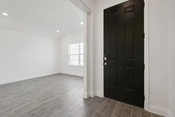 an empty room with wooden floor and closet