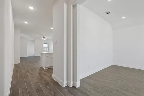 a view of a room with wooden floor