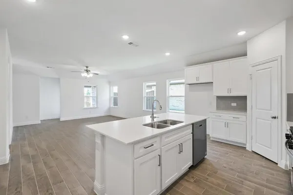 a kitchen with white cabinets and white appliances