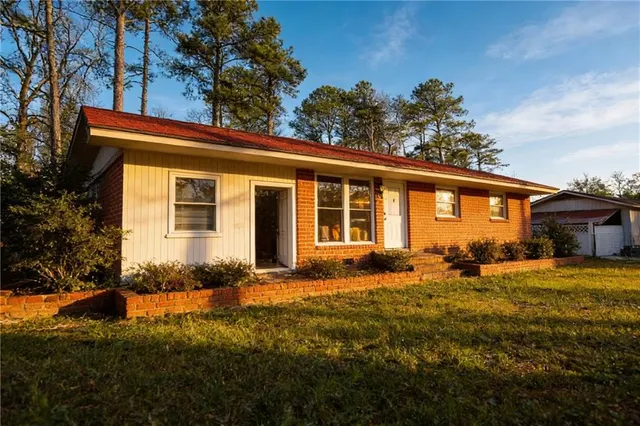 a front view of a house with a garden
