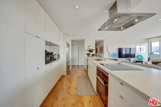 a kitchen with a stove a sink and a refrigerator
