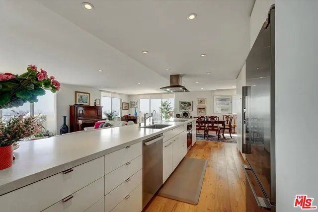 a bed sitting in a spacious bedroom next to a window