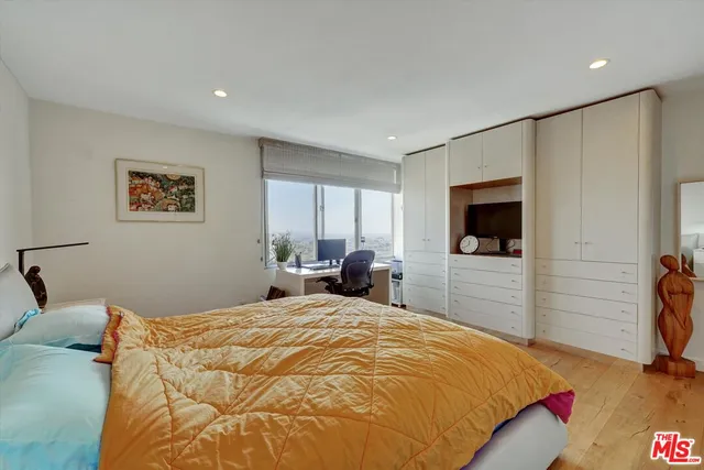 a view of a workspace with furniture and book shelf