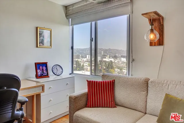 a bedroom with a bed and a potted plant
