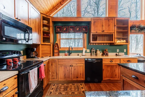 a kitchen with stainless steel appliances granite countertop a stove and a sink