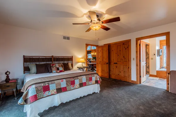 a bedroom with a bed and a chandelier