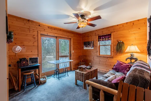 a living room with furniture and a floor to ceiling window