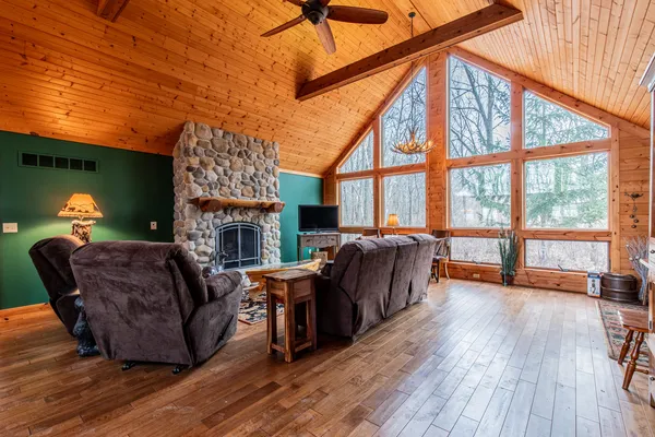 a living room with furniture a fireplace and a large window