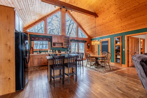 a view of a patio with table and chairs floor to ceiling window with wooden floor