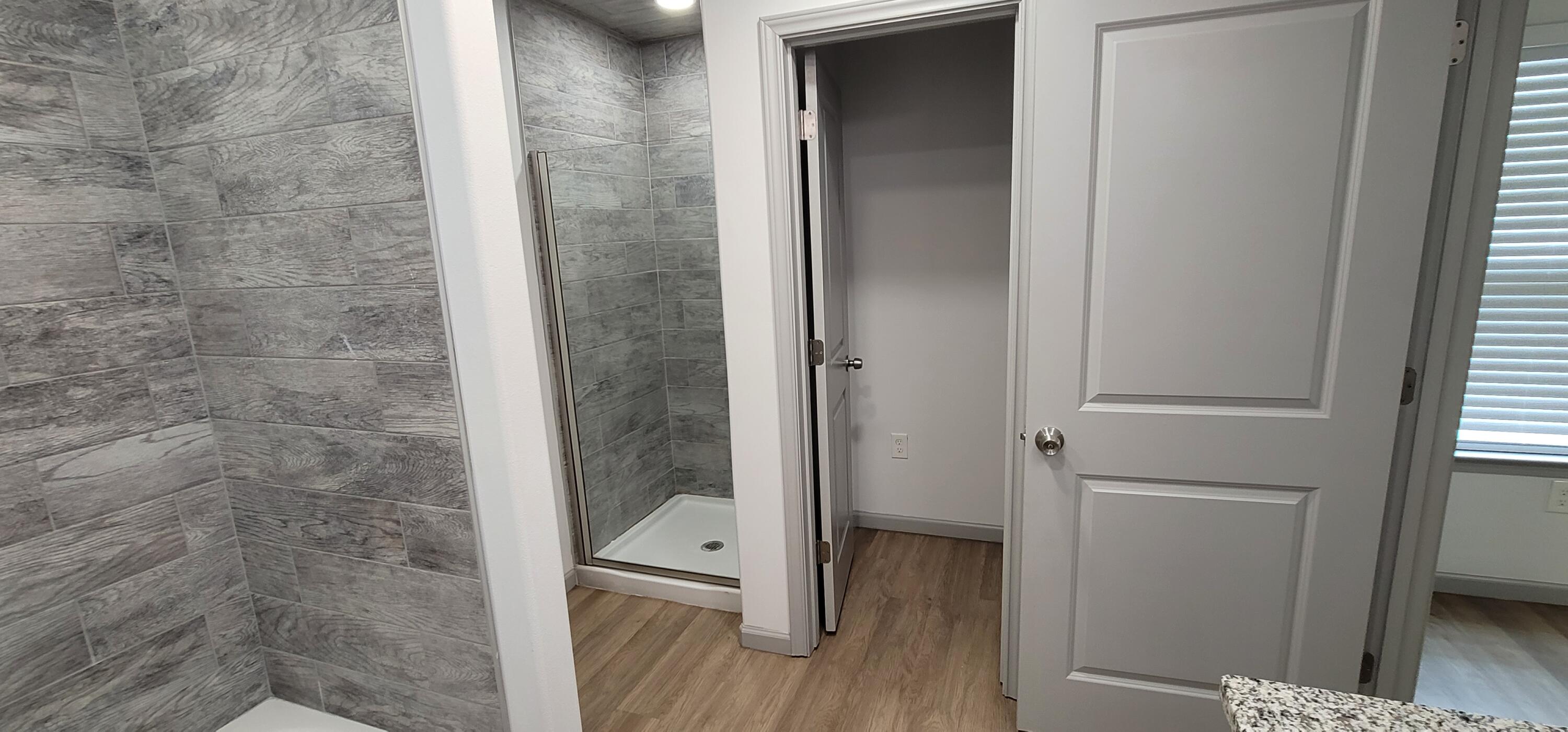 2110 88th Street Lubbock, TX 79423 - Photo 11 of 22 a bathroom with a glass door shower