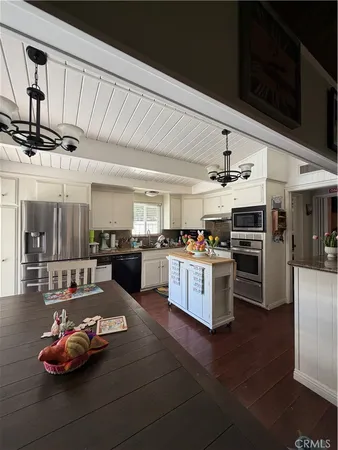 a kitchen with a sink cabinets and appliances