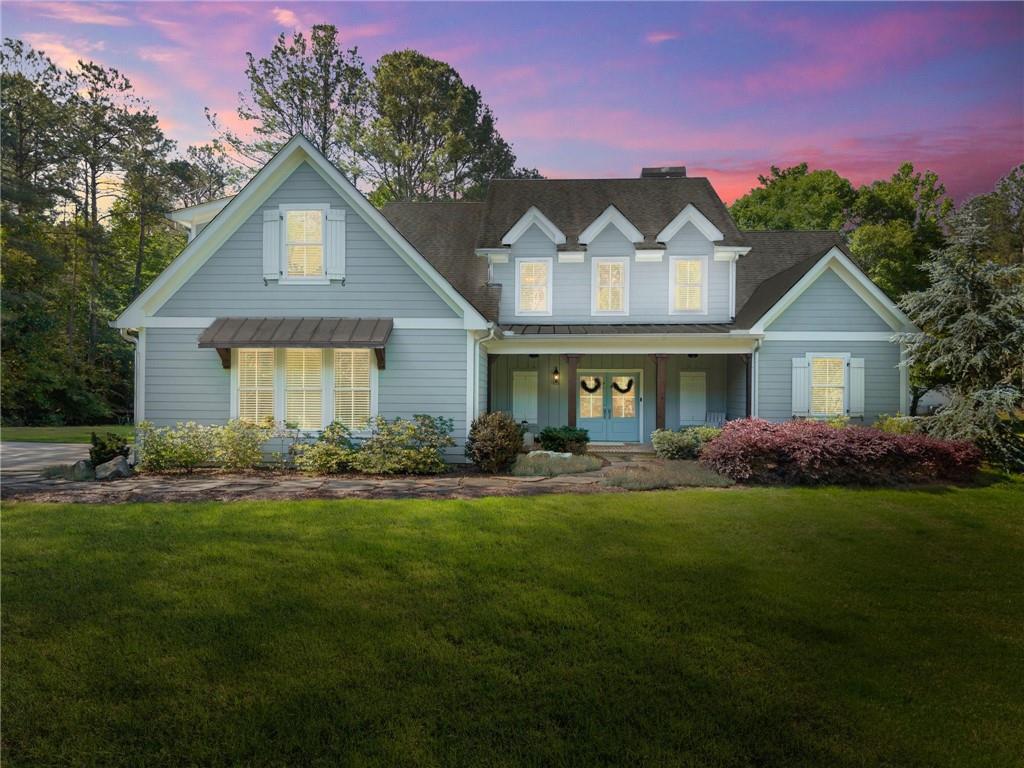 5822 John Burruss Road Cumming, GA 30040 - Photo 48 of 65 a front view of a house with a garden