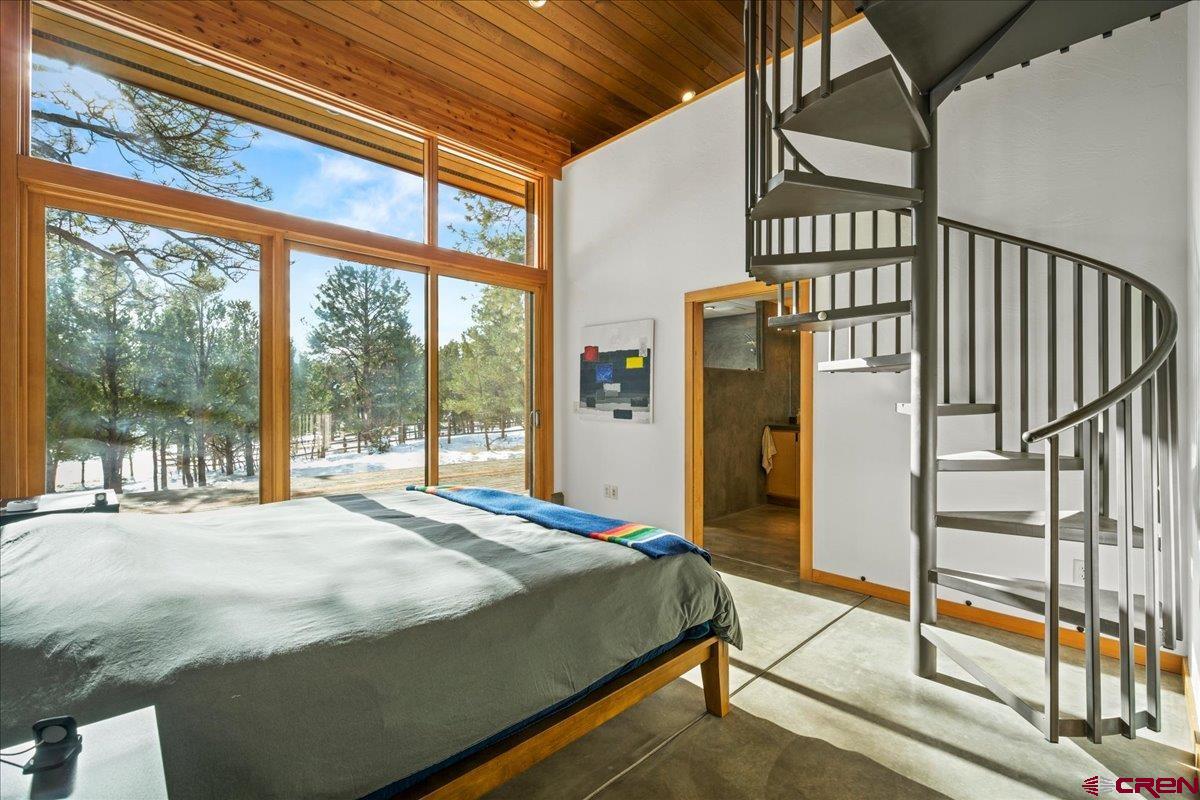 412 South Badger Trail Ridgway, CO 81432 - Photo 13 of 45 a bed sitting in a bedroom next to a window