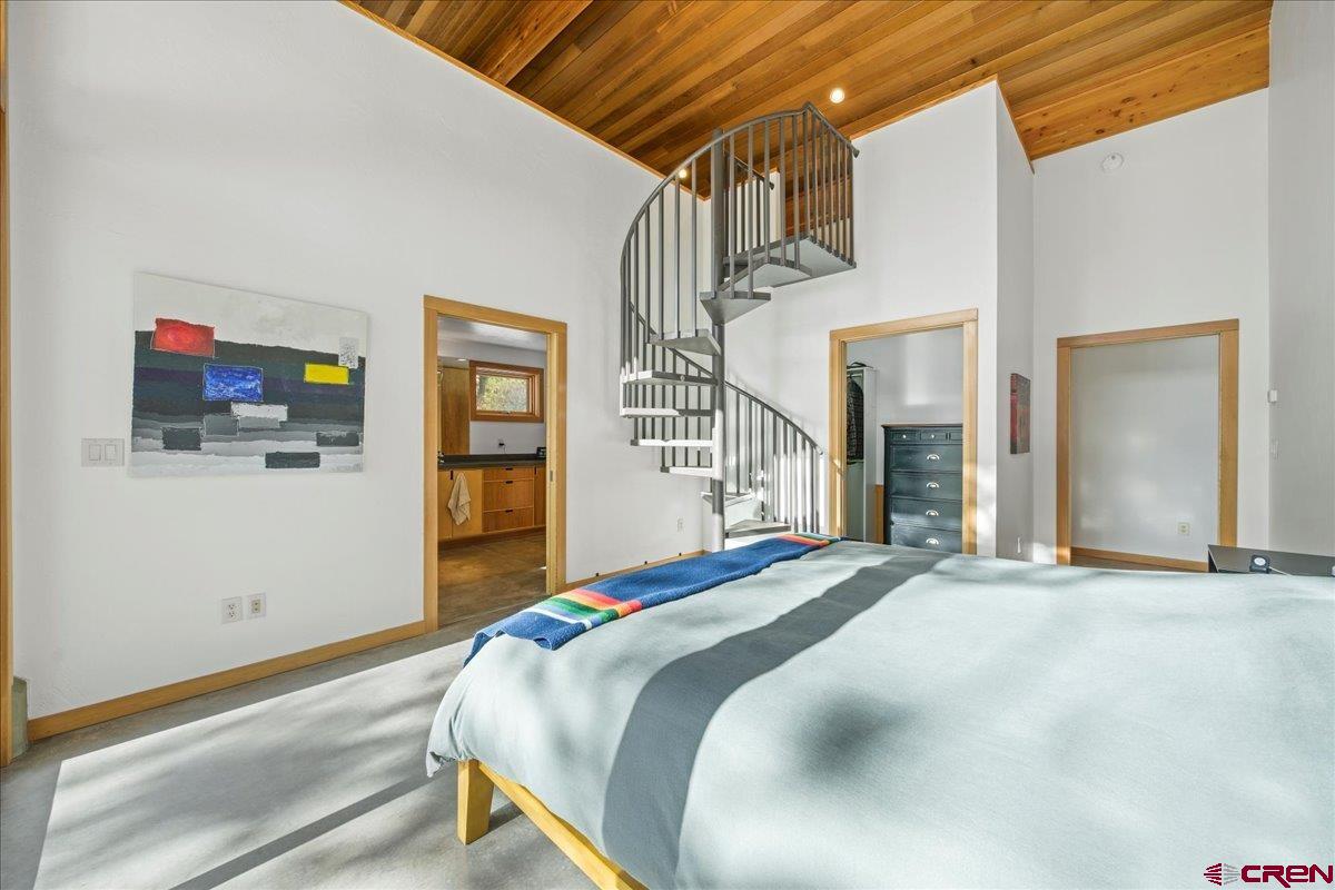 412 South Badger Trail Ridgway, CO 81432 - Photo 14 of 45 a bed room with a bed and a tv on the wall