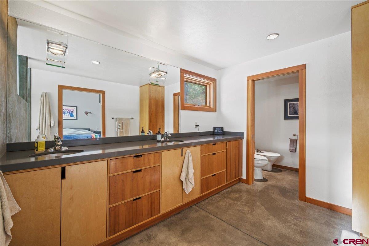 412 South Badger Trail Ridgway, CO 81432 - Photo 16 of 45 a spacious bathroom with a granite countertop sink and a mirror