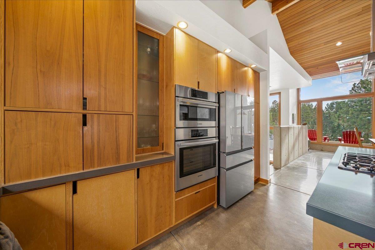 412 South Badger Trail Ridgway, CO 81432 - Photo 8 of 45 a kitchen with stainless steel appliances a refrigerator and cabinets