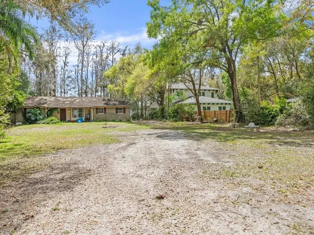 a view of a house with yard and sitting area