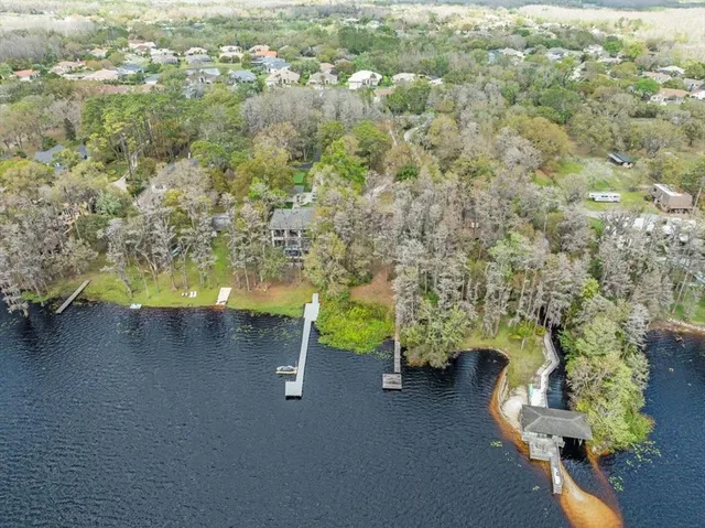 an aerial view of a house with a yard basket ball court and outdoor seating