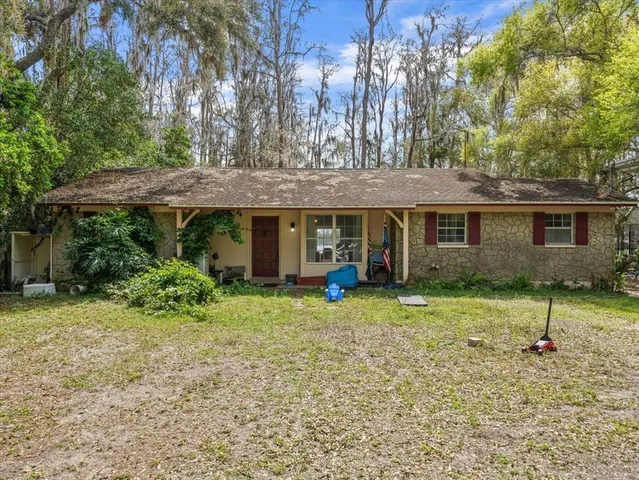 a backyard of a house with yard and outdoor seating