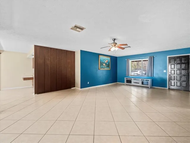a view of an empty room with closet and window