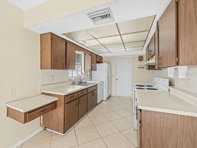 a kitchen that has a sink and a stove