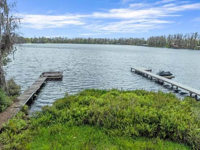 a view of a lake with houses in the back