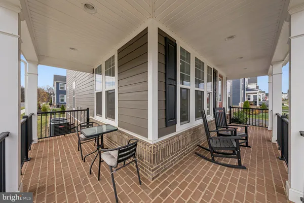 a balcony with chairs and wooden floor