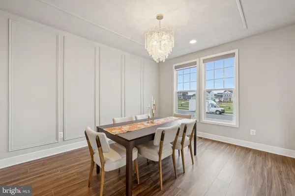 a view of a dining room with furniture wooden floor and chandelier