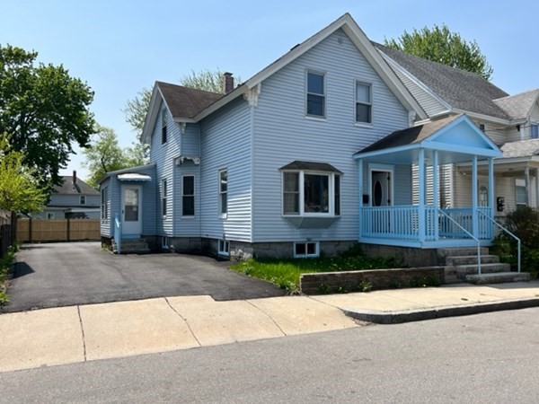 a view of a house with a yard and plants