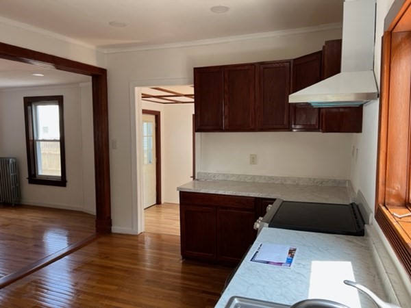 142 Shaw Street Lowell, MA 01851 - Photo 11 of 31 a kitchen with a sink and a refrigerator