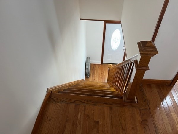 142 Shaw Street Lowell, MA 01851 - Photo 16 of 31 a view of a bedroom with a bed and wooden floor