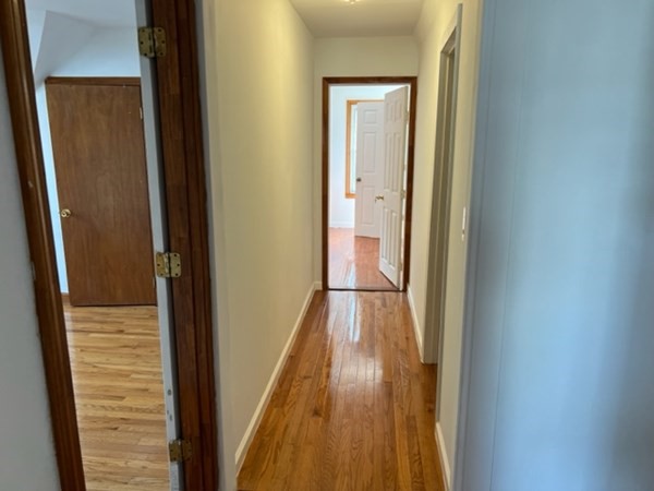 142 Shaw Street Lowell, MA 01851 - Photo 18 of 31 a view of a hallway with wooden floor