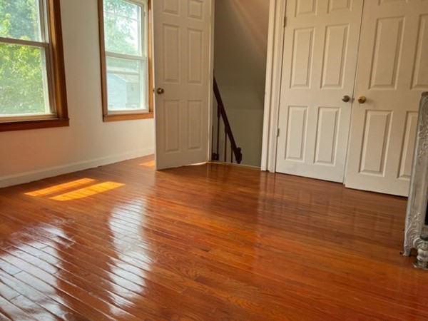 142 Shaw Street Lowell, MA 01851 - Photo 19 of 31 an empty room with wooden floor and a window