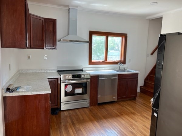 142 Shaw Street Lowell, MA 01851 - Photo 10 of 31 a kitchen with granite countertop a stove and a refrigerator