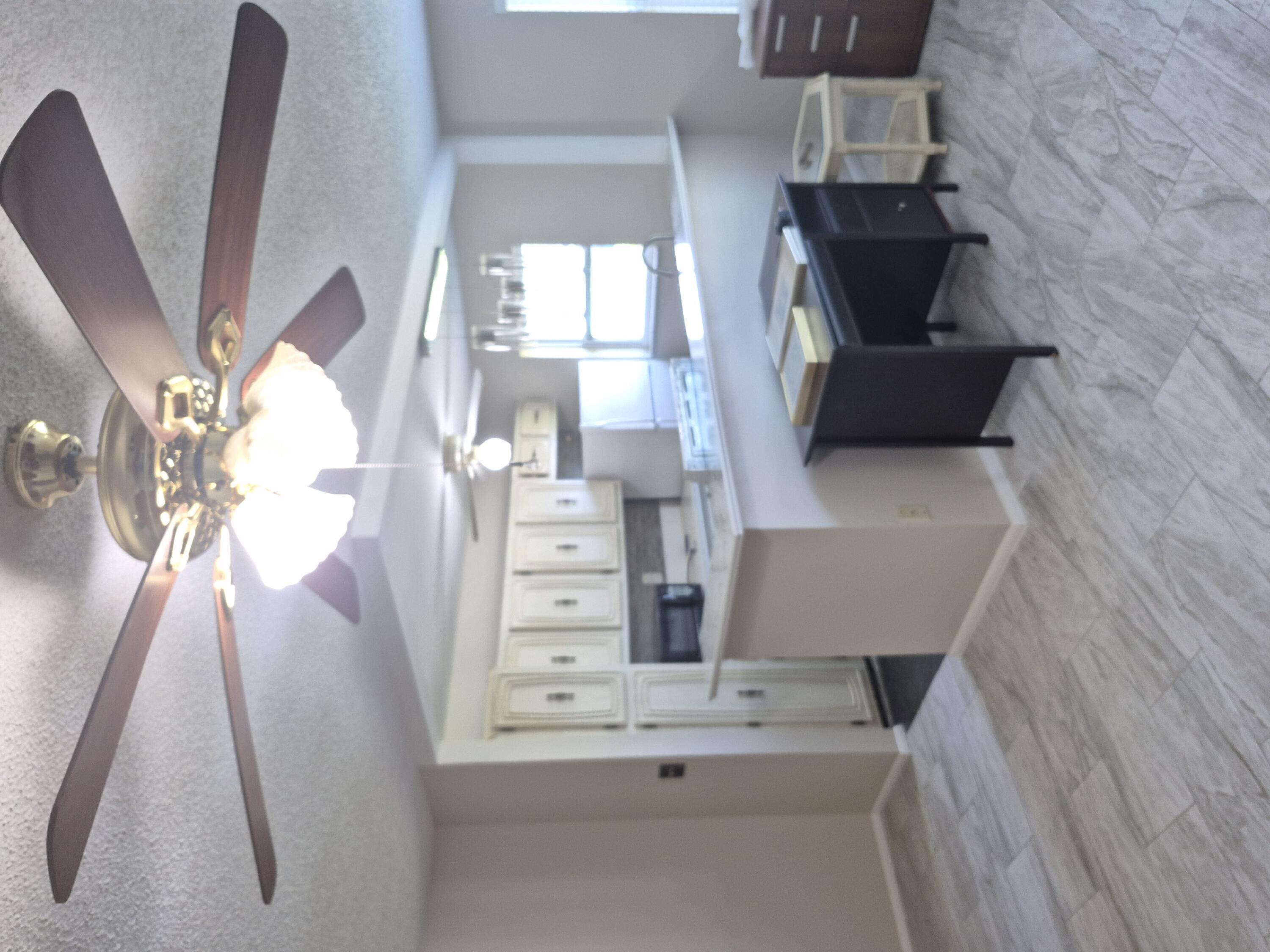 a kitchen with granite countertop a sink cabinets and wooden floor