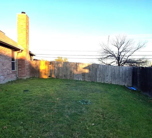 a view of a garden with a building in the background