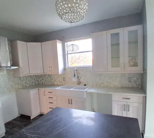 a kitchen with a sink and cabinets