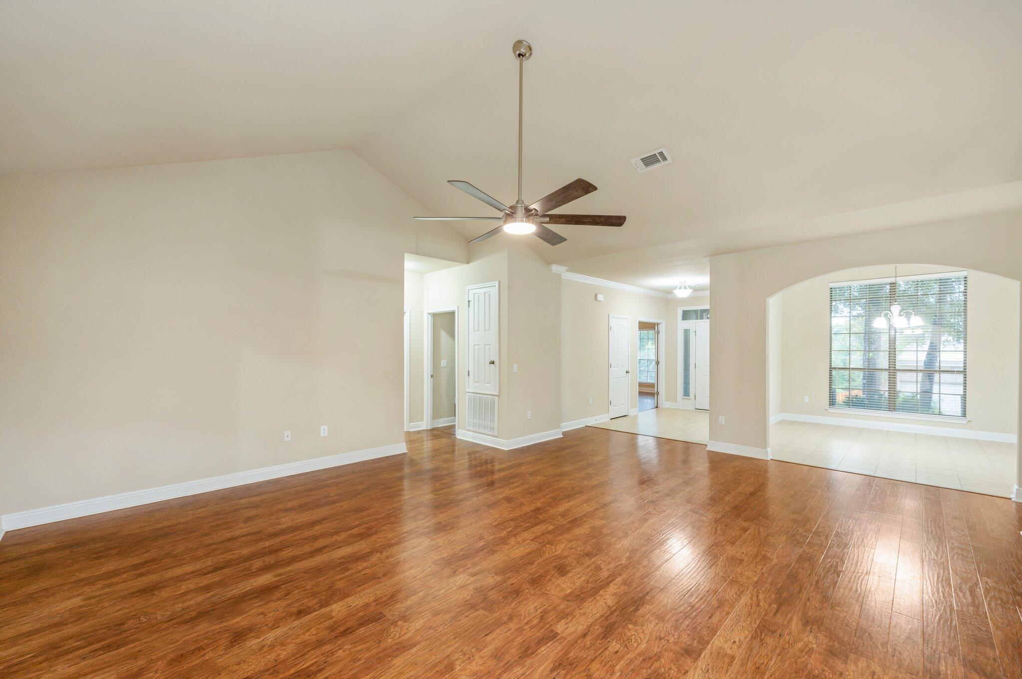 615 Red Fern Road Crestview, FL 32536 - Photo 12 of 33 a view of an empty room with wooden floor and a window