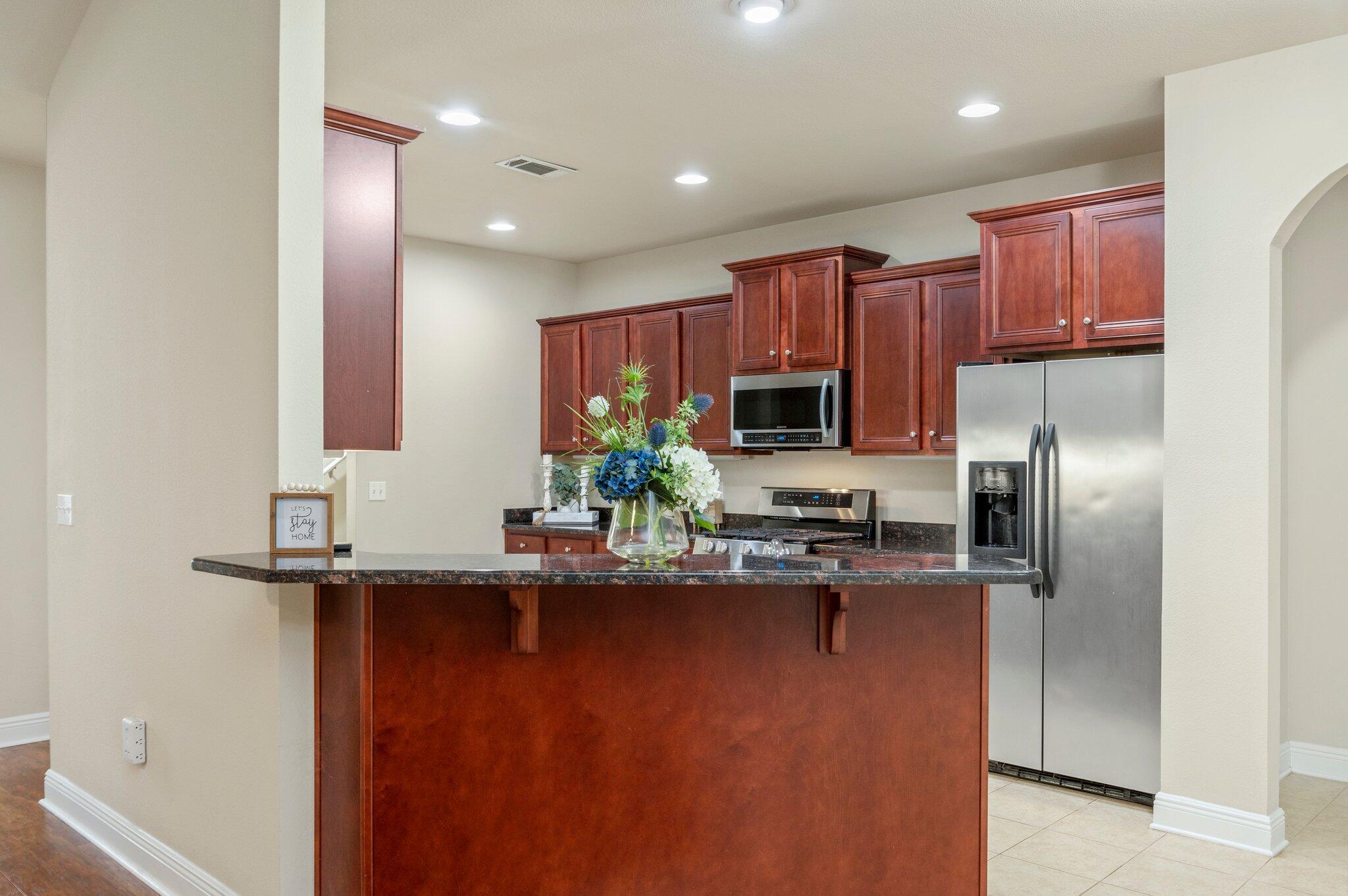 615 Red Fern Road Crestview, FL 32536 - Photo 16 of 33 a kitchen with kitchen island granite countertop a sink and refrigerator