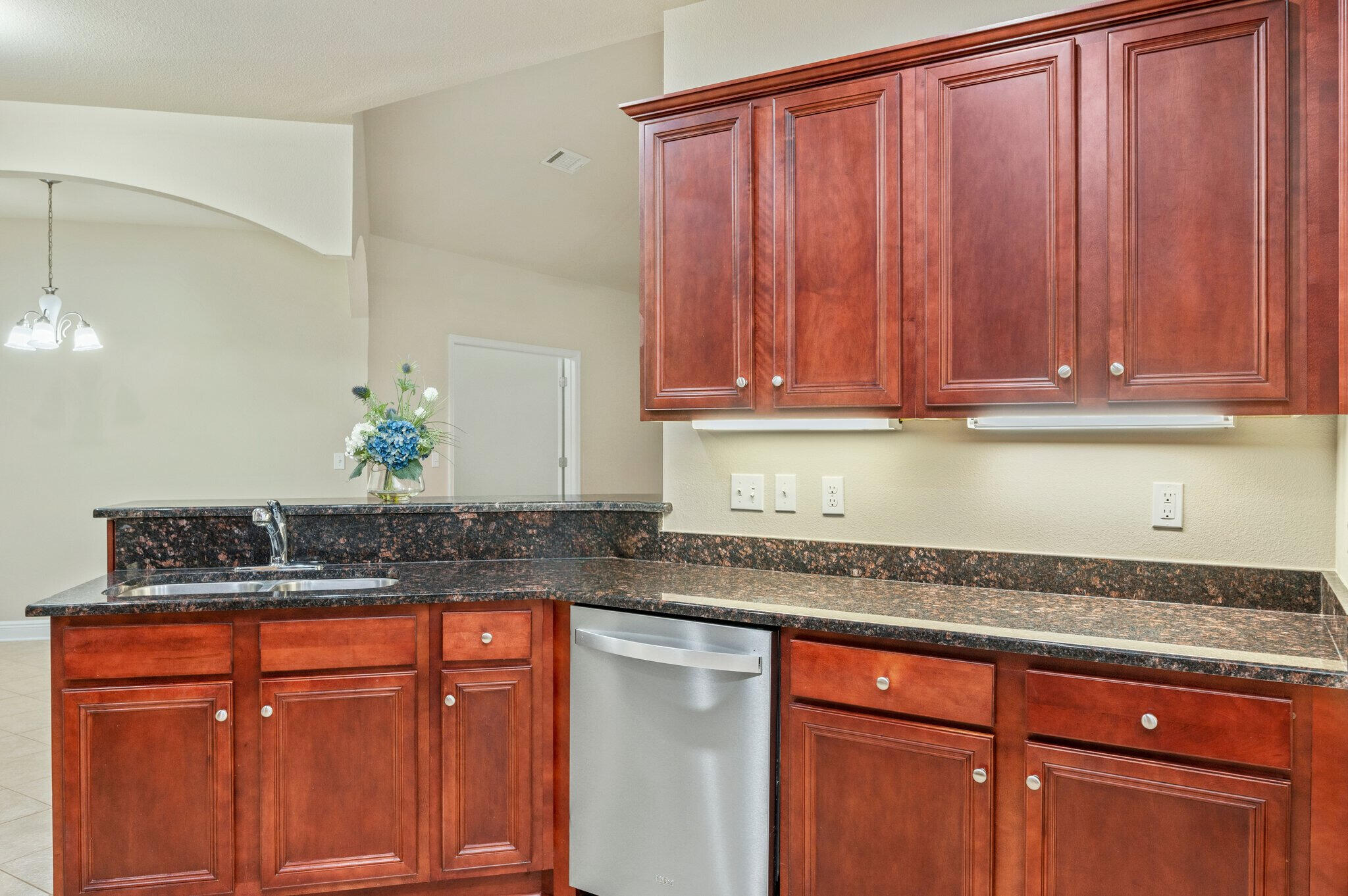 615 Red Fern Road Crestview, FL 32536 - Photo 17 of 33 a sink with granite countertop wooden cabinets
