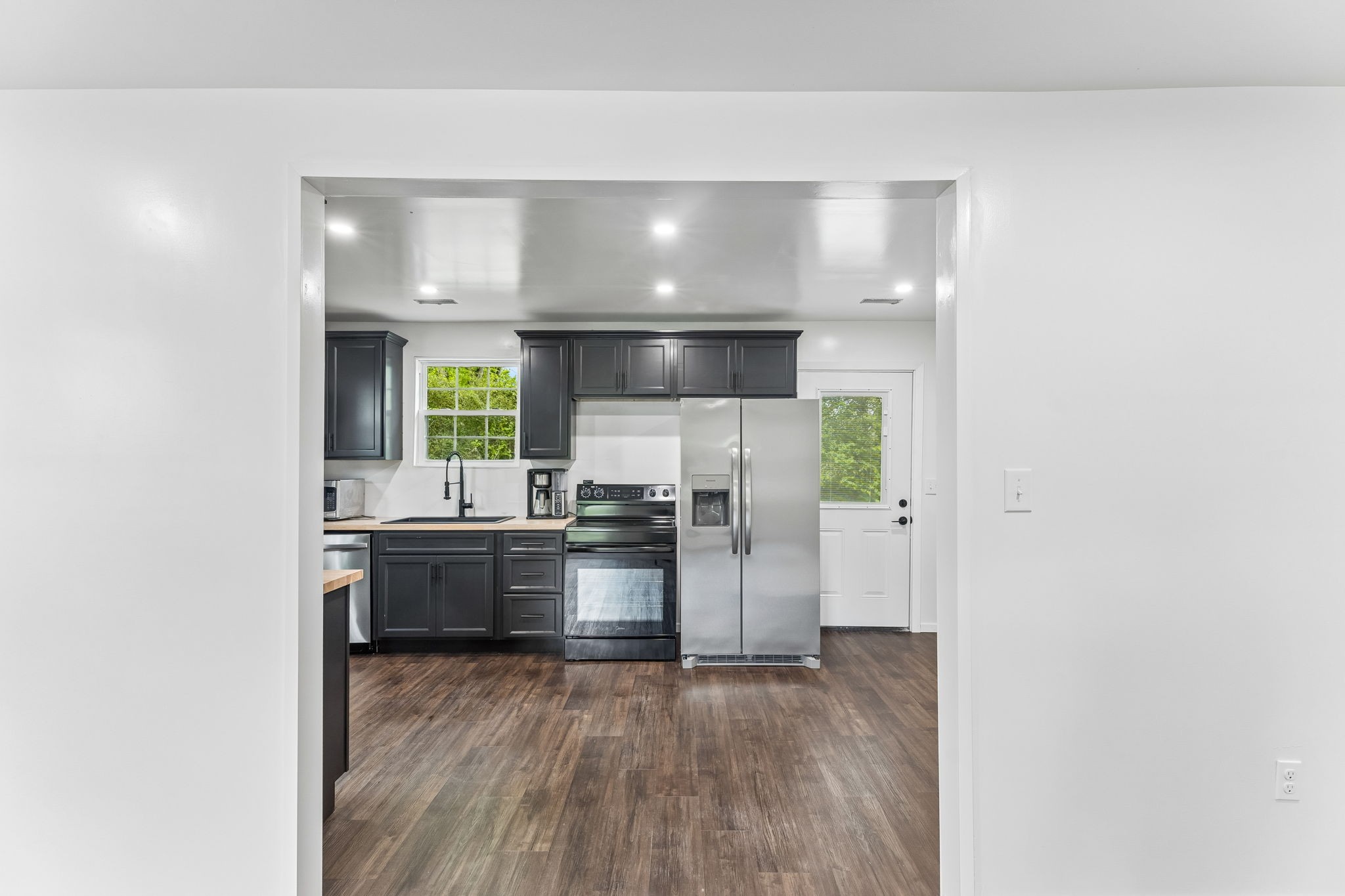 330 West Washington Street Pulaski, TN 38478 - Photo 12 of 36 a kitchen with stainless steel appliances a refrigerator and a stove top oven