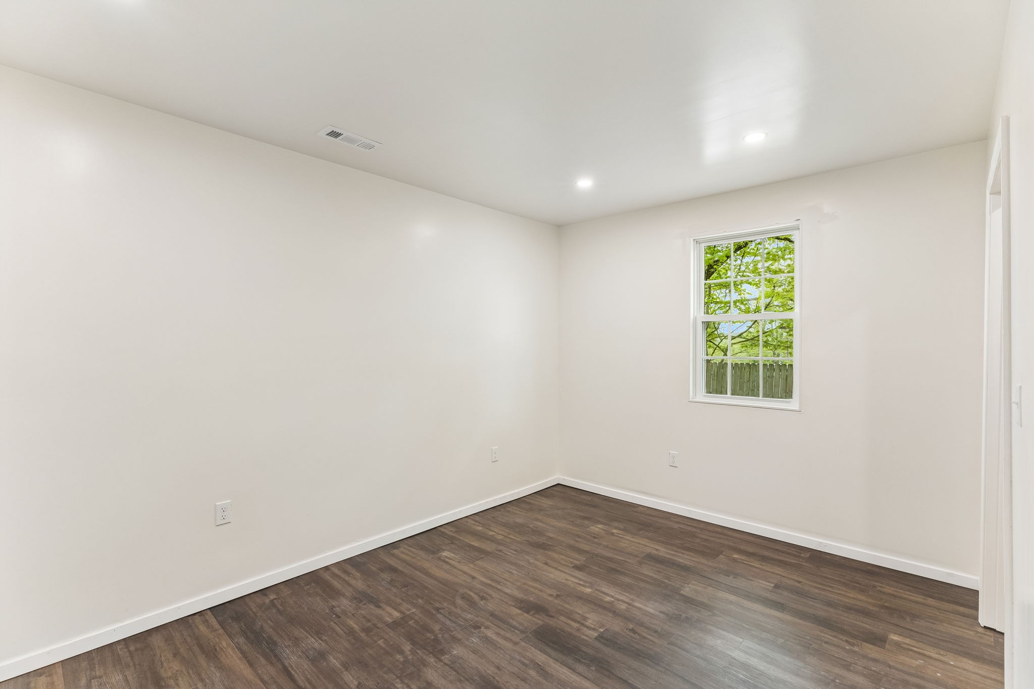 330 West Washington Street Pulaski, TN 38478 - Photo 17 of 36 an empty room with wooden floor and window