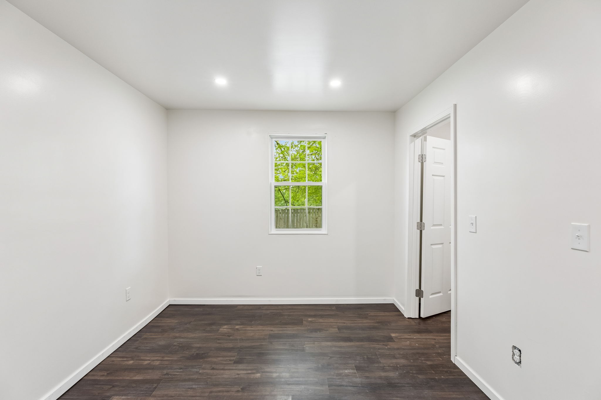 330 West Washington Street Pulaski, TN 38478 - Photo 18 of 36 an empty room with wooden floor and windows
