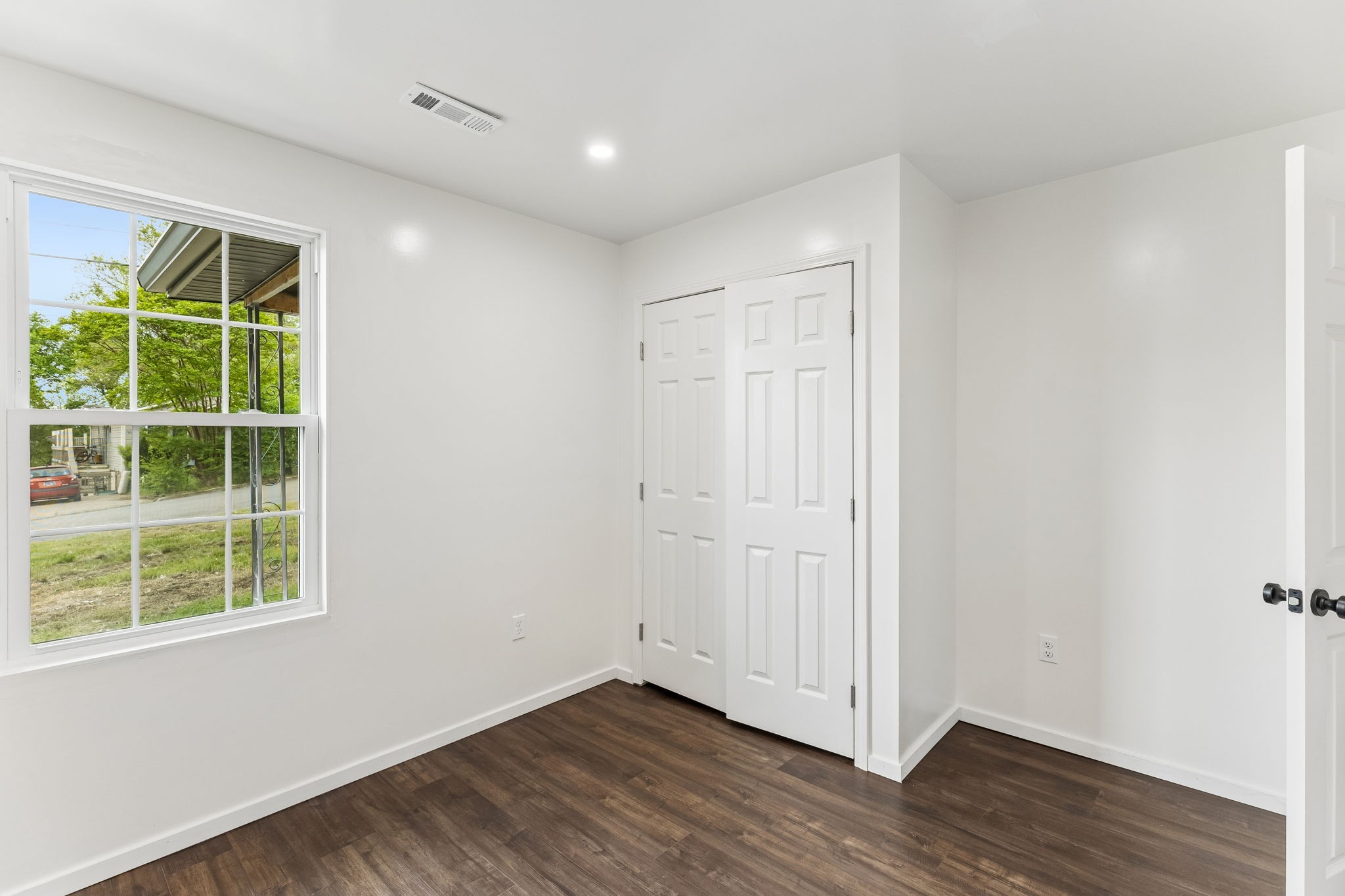 330 West Washington Street Pulaski, TN 38478 - Photo 28 of 36 an empty room with wooden floor and windows