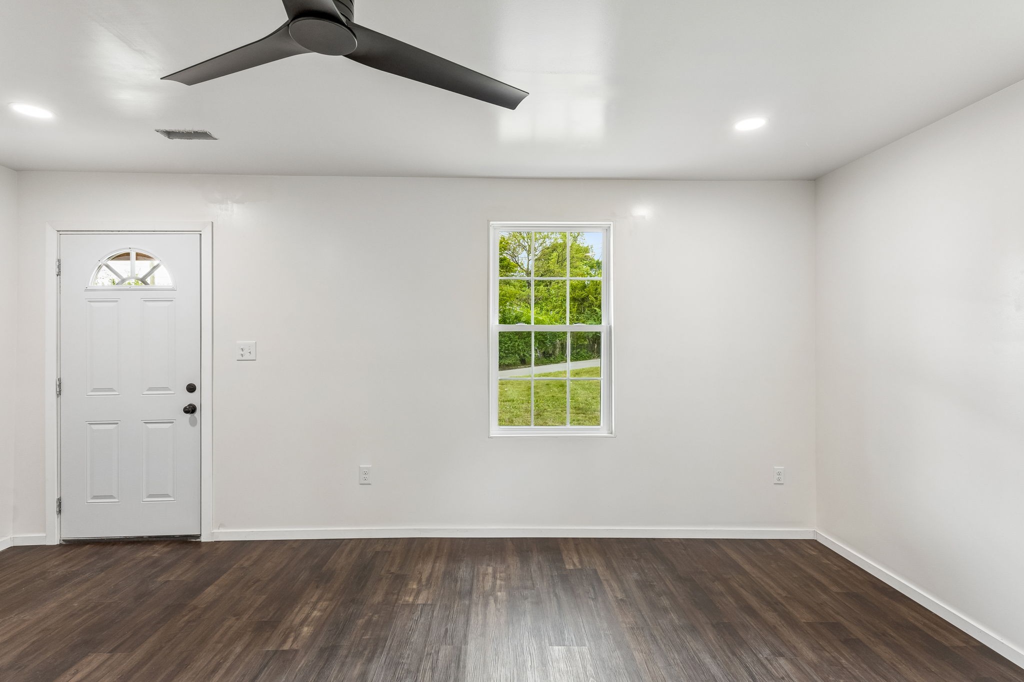 330 West Washington Street Pulaski, TN 38478 - Photo 7 of 36 an empty room with wooden floor chandelier fan and windows